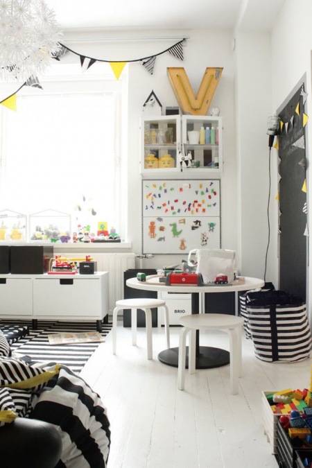 Biało-czarny pokój dla dziecka z girlandą z proporczyków w stylu skandynawskim