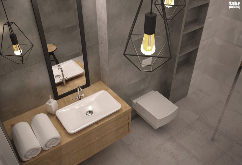 Aranżacja szarej łazienki z oryginalnymi lampami w industrialnym stylu