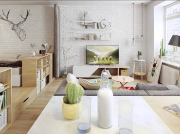 Białe cegły na ścianie idealnie wpisują się w skandynawski charakter mieszkania i tworzą we wnętrzu oryginalny klimat. Po lewej stronie wydzielono część sypialnianą za pomocą podwyższenia i sprytnego oddzielenia łóżka od salonu niskimi...