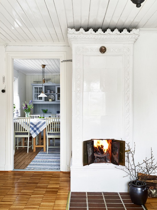 Stylowy biały piec i niebieska tradycyjna kuchnia w stylu skandynawskim