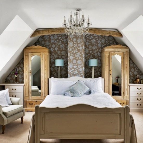 Szaro-niebieska tapeta,żyrandol i stylowe szafy z lustrami w klasycznej sypialni na poddaszu