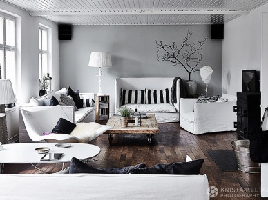 Szara ściana,ciemnobrązowa podłoga,białe meble w lnianych białych ubrankach,czarne detale dekoracyjne w salonie (26563)