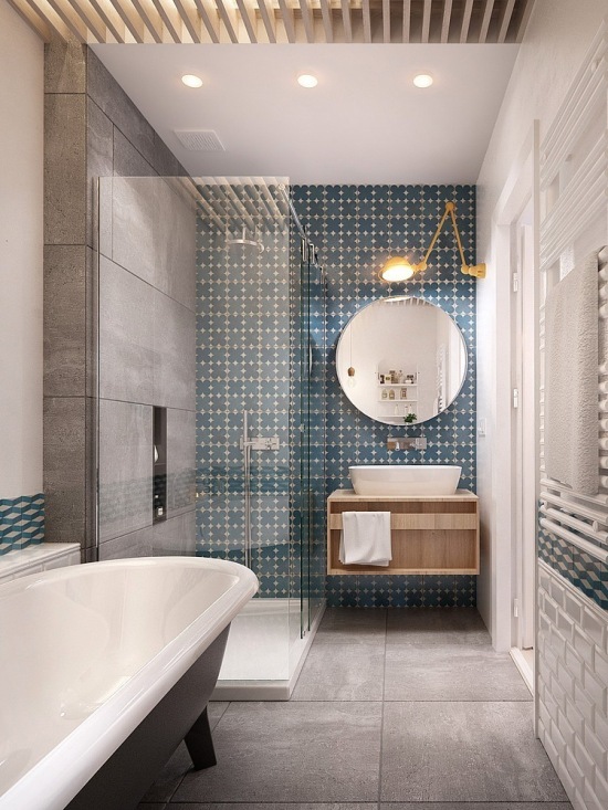 Szara a`la beton i turkusowa płytka na ścianie w łazience z okrągłym lustrem   i drewnianą szafka pod umywalką
