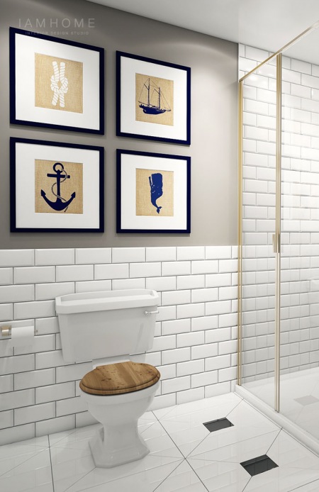Morskie grafiki na szarej ścianie w łazience z biała glazurą cegiełką i drewnianymi detalami