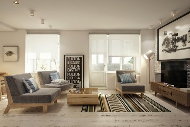 Deski podłogowe z naturalnbego drewna,biała cegła na ścianie,drewniane fotele z szarą tapicerką w tkaninie i tkany dywan w paski w salonie