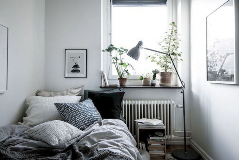 Mała sypialnia z dekoracją z roślin na parapecie