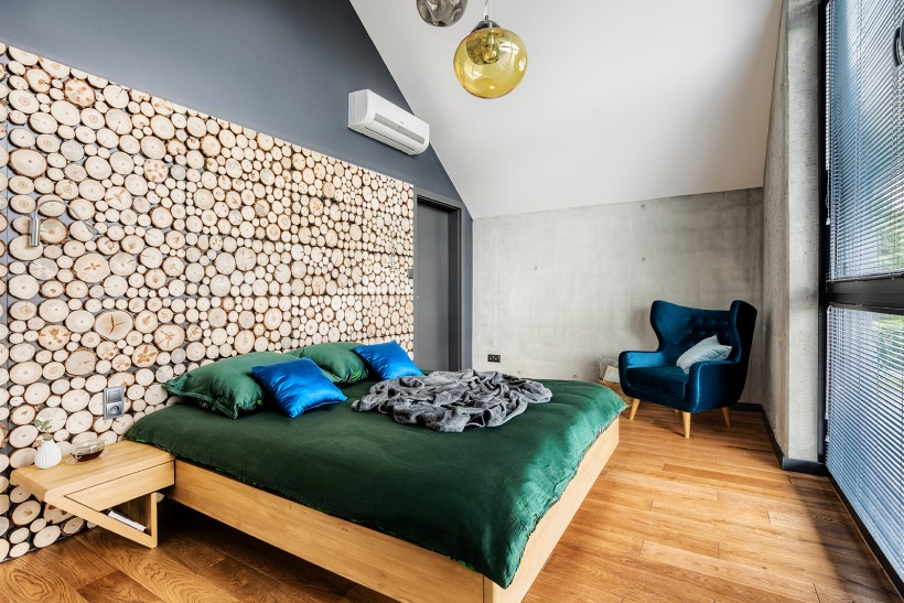 Eklektyczna sypialnia z drewnianą podłogą i oryginalną dekoracją na ścianie