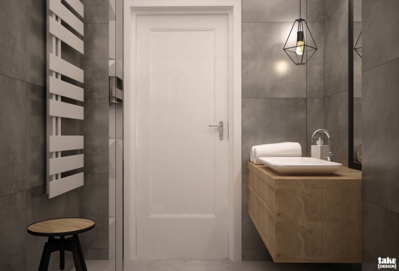 Aranżacja łazienki z szarymi ścianami i drewnianymi meblami