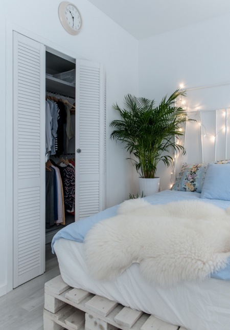 Aranżacja biało-błękitnej sypialni z małą garderobą