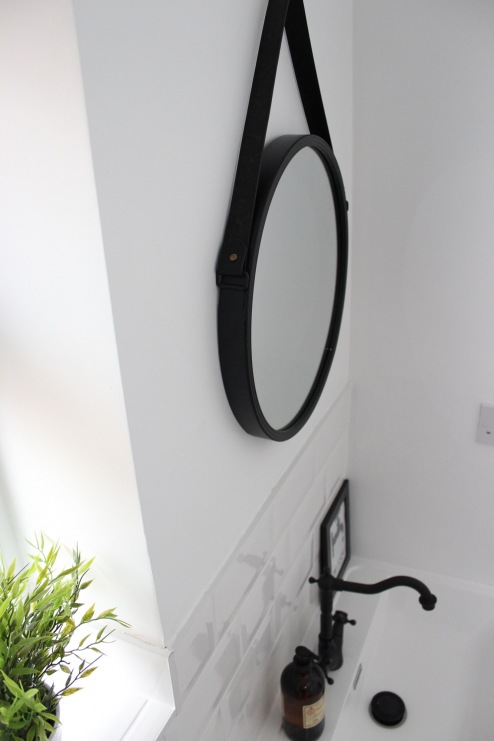 Czarne lustro o okrągłym kształcie zdecydowanie ozdabia łazienkową przestrzeń. W aranżacji warto także zwrócić uwagę na...