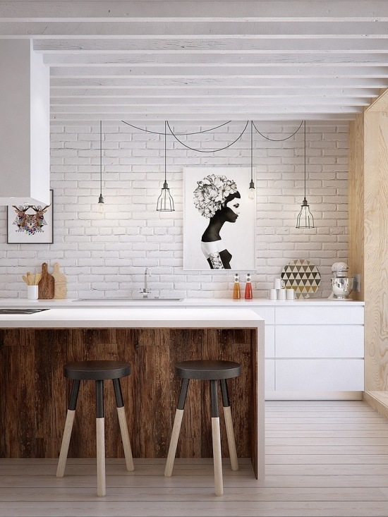 Biała cegła na ścianie,białe szafki kuchenne,druciane abażury i żarówki na kablach,bialy okap nad wyspą kuchenną ze stołkami