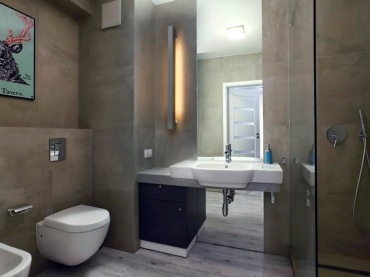 Ciemna łazienka łączy w sobie cechy skandynawskiego stylu z industrialnym klimatem. Jednolitą przestrzeń w kamiennym...