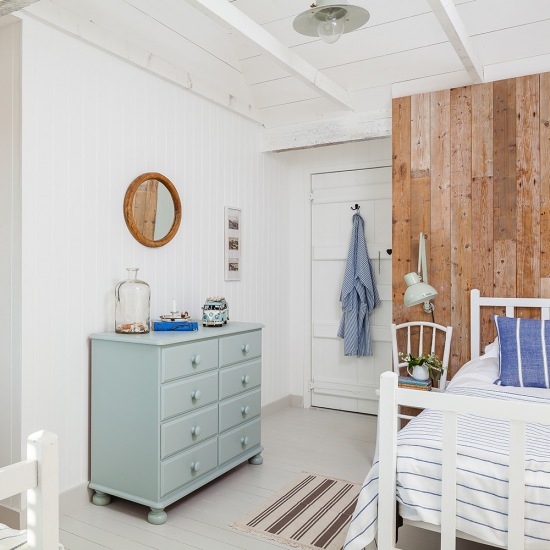 Przytulna biała sypialnia z drewnianymi dodatkami