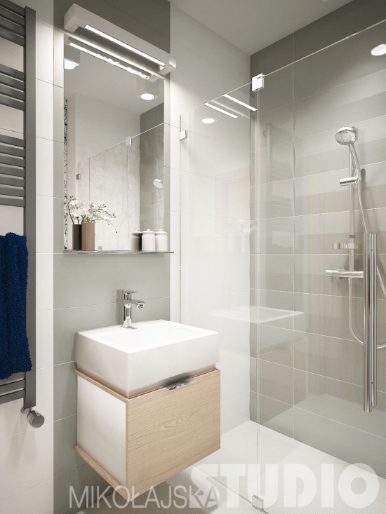 Paktyczna mała łazienka z głęboka prostokatną umywalką,kabiną z natryskiem w biało-szarym kolorze