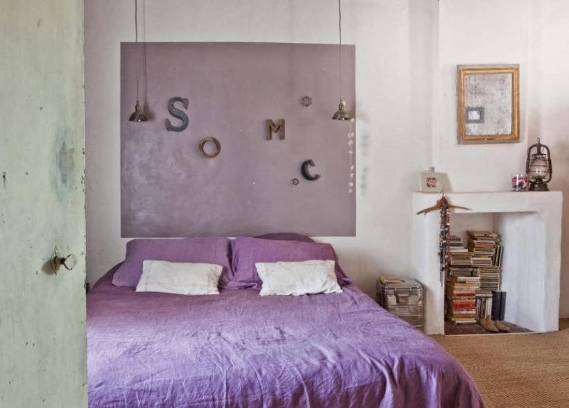Wrzosowy kolor w aranżacji sypialni vintage z białą atrapą kominka