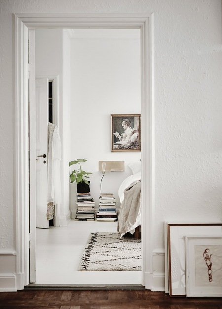 Białe wnętrza skandynawskiego domu z mieszanką mebli i detali