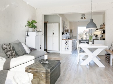 Aranżacja mieszkania w stylu skandynawskim w odcieniach bieli i szarości z naturalnymi motywami