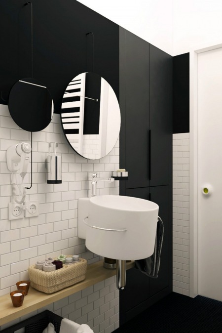 Czarne ściany i białe płytki w łazience
