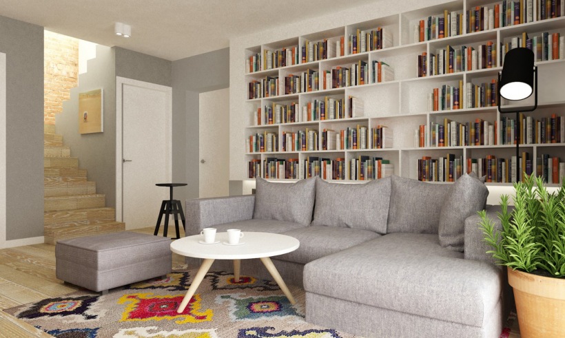 Szara sofa i wzorzysty dywan w salonie