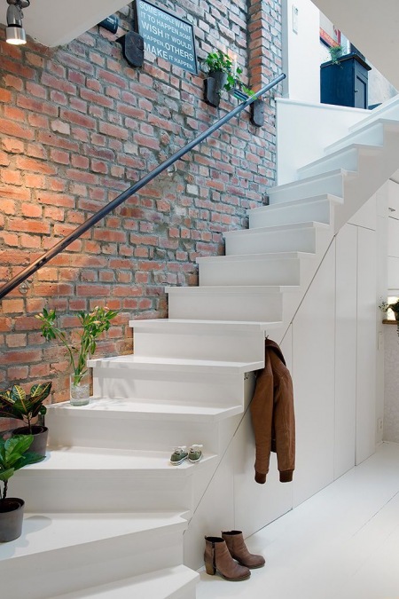 Najpiękniejsze białe schody przy ścianie z czerwonej cegły