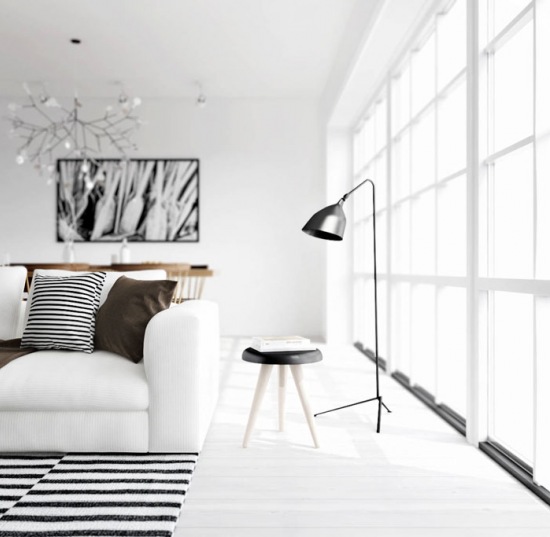 Czarna lampa podłogowa w stylu skandynawskim,dywan w biało-czarne paski na białej podło0dze,żyrandol drzewko,biało-czarna fotografia na ścianie