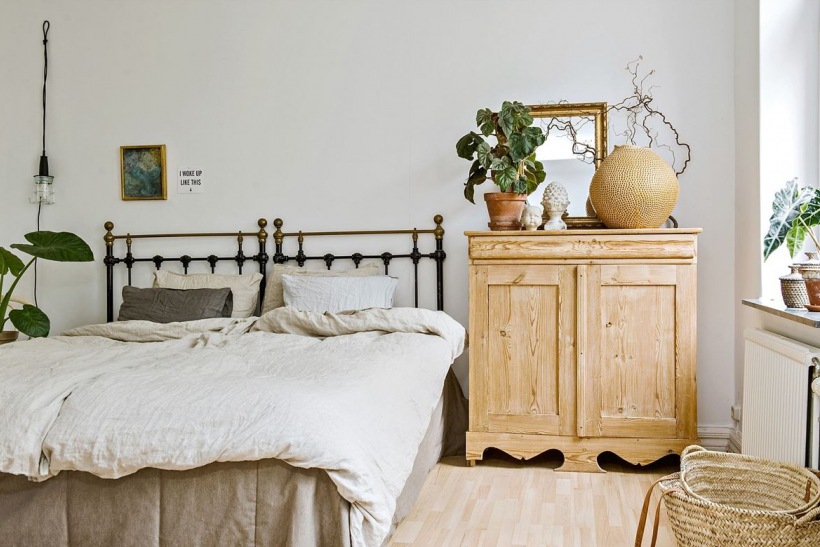 Drewniana komoda i oryginalne dekoracje w sypialni