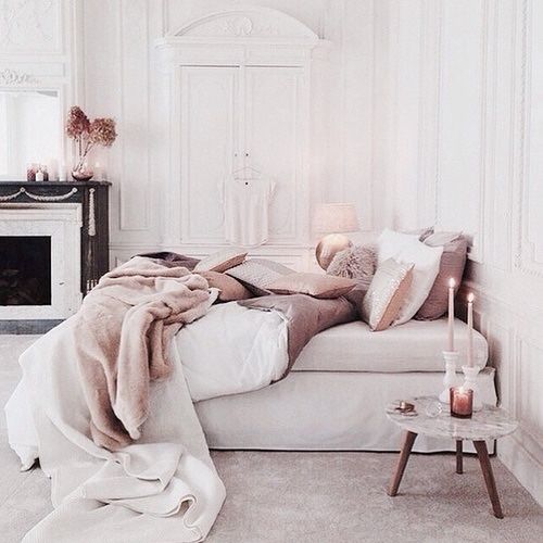 Biała sypialnia z kominkiem, z dodatkami w pastelowym różu