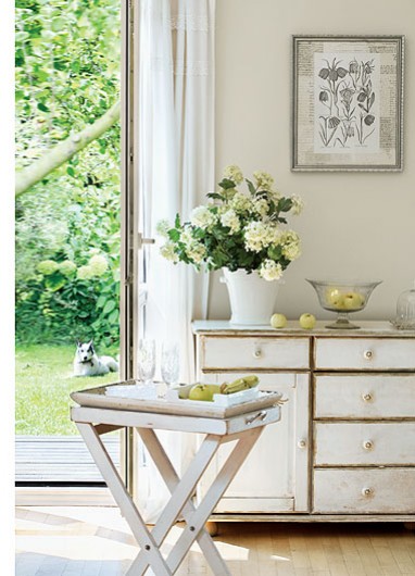 Biała przetarta komoda z szufladami ,art-druki roślinne i biały stolik z tacą